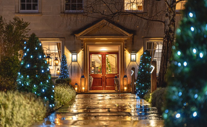 Christmas lights covering trees leading up to Royal Crescent Hotel